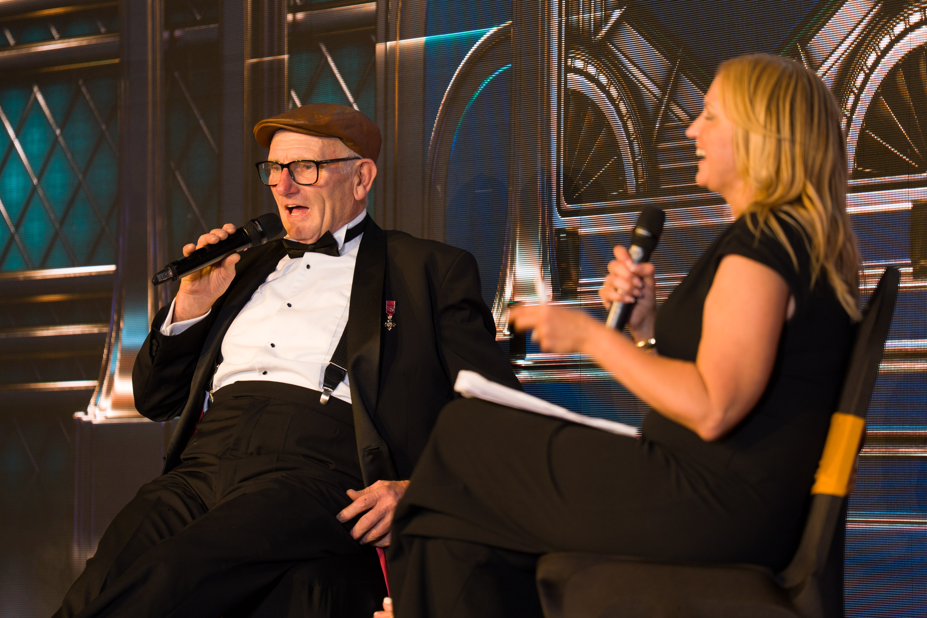 Frank Rothwell speaking on stage with host Caroline Whitmore